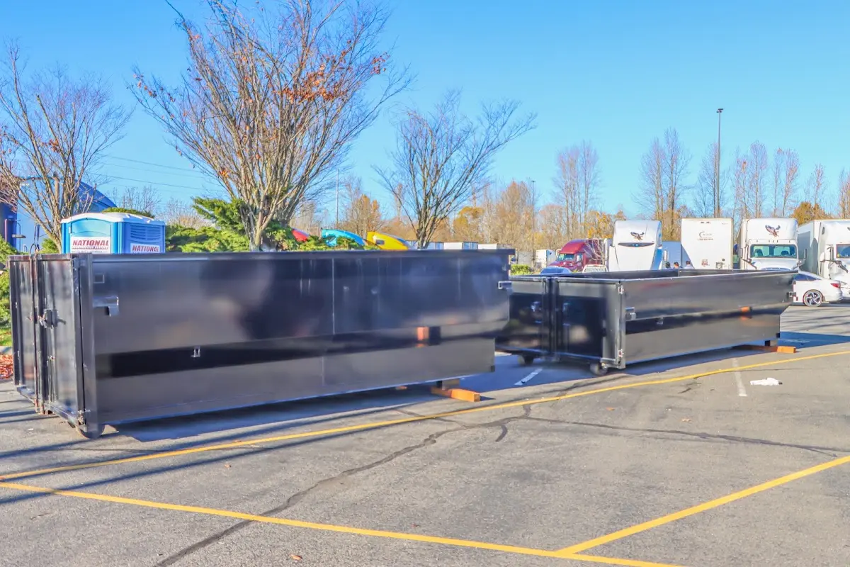 Professional dumpster rental service with roll-off container on residential driveway in Frisco